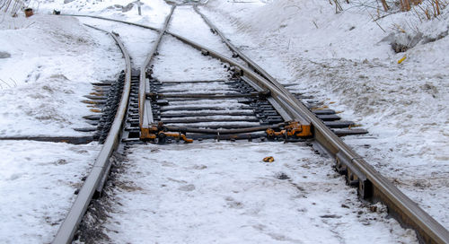 High angle view of railroad tracks on snow covered field
