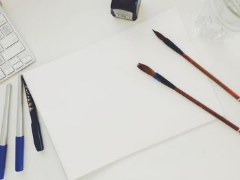 High angle view of pencils on paper