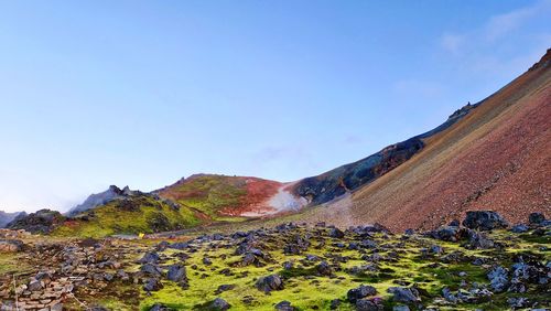 Amazing colorful view of volcanic mountains and lava field against clear sky