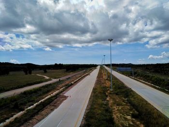 Road passing through landscape against sky