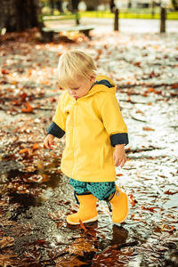 Rear view of boy standing on field