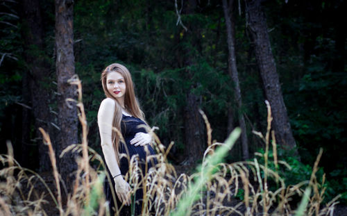 Portrait of young woman in forest