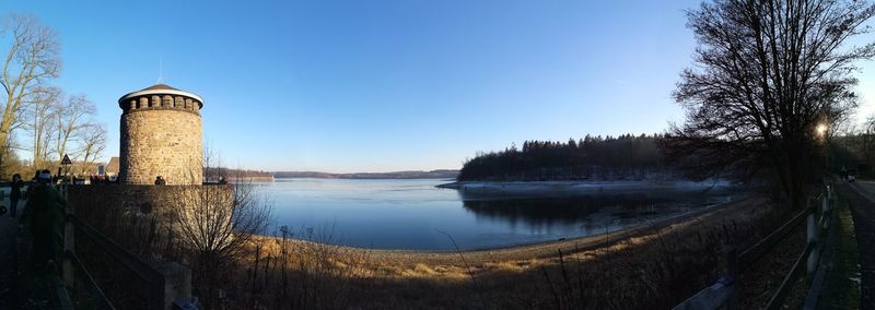 Scenic view of lake against clear blue sky