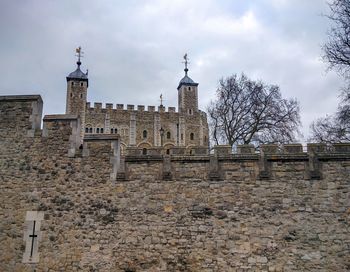 Low angle view of historical building against cloudy sky