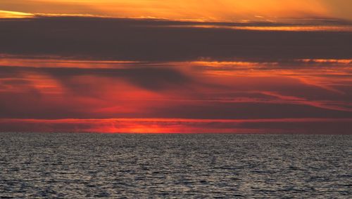 Scenic view of sea against romantic sky at sunset