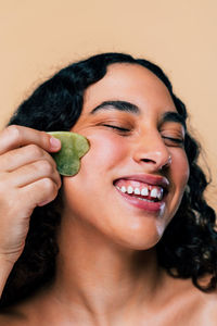 Close-up of young woman holding plant