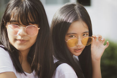 Close-up portrait of friends wearing sunglasses