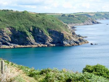 Scenic view of sea and coast against sky