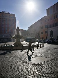 People in city against sky