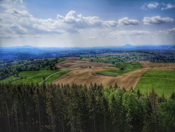 Scenic view of agricultural field against sky