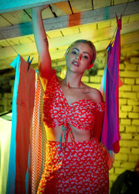 Portrait of woman with arms raised