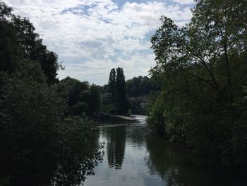 Scenic view of river against cloudy sky