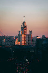 High angle view of illuminated buildings in city at sunset