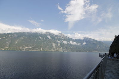 Scenic view of lake by mountains against sky