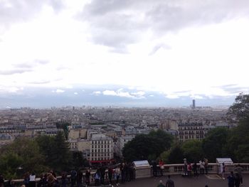 People in city against sky