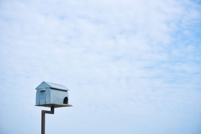 Low angle view of birdhouse against sky