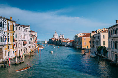 Boats in canal with buildings in background