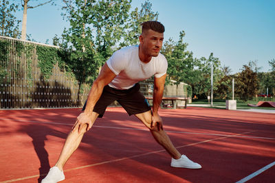 Full length of man exercising on road