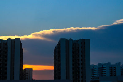 Low angle view of buildings against sky during sunset