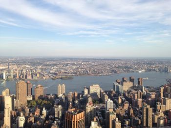 Aerial view of buildings in city against sky