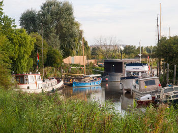 Boats moored in lake against sky