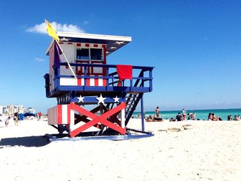 Lifeguard hut at beach against sky