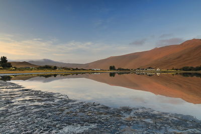 1126 sumu jaran lake and badain jaran desert temple-sand megadunes reflected on mirror water. china.