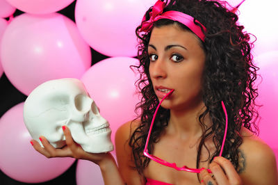 Close-up of young woman with balloons