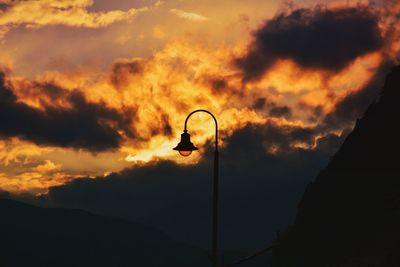 Low angle view of street light against orange sky