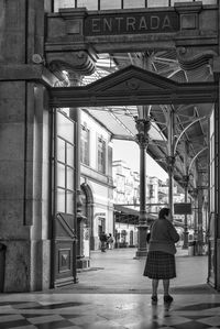 Rear view of a man walking on the road