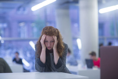 Employee in an office thinking, upset