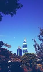 Low angle view of buildings against clear blue sky