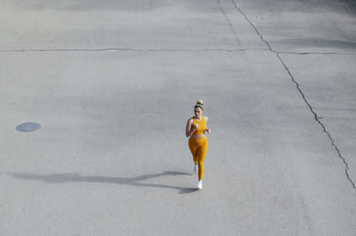 Young athlete jogging on road