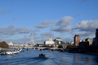 Bridge over river with buildings in background