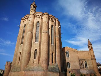 Low angle view of church against cloudy sky