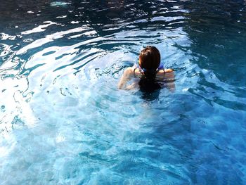 High angle view of woman swimming in pool