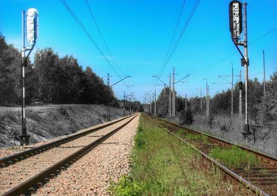 Railroad tracks against blue sky