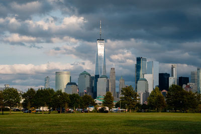 Buildings in city against cloudy sky