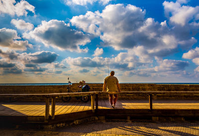 Boy against cloudy sky