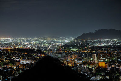 High angle view of illuminated city buildings at night