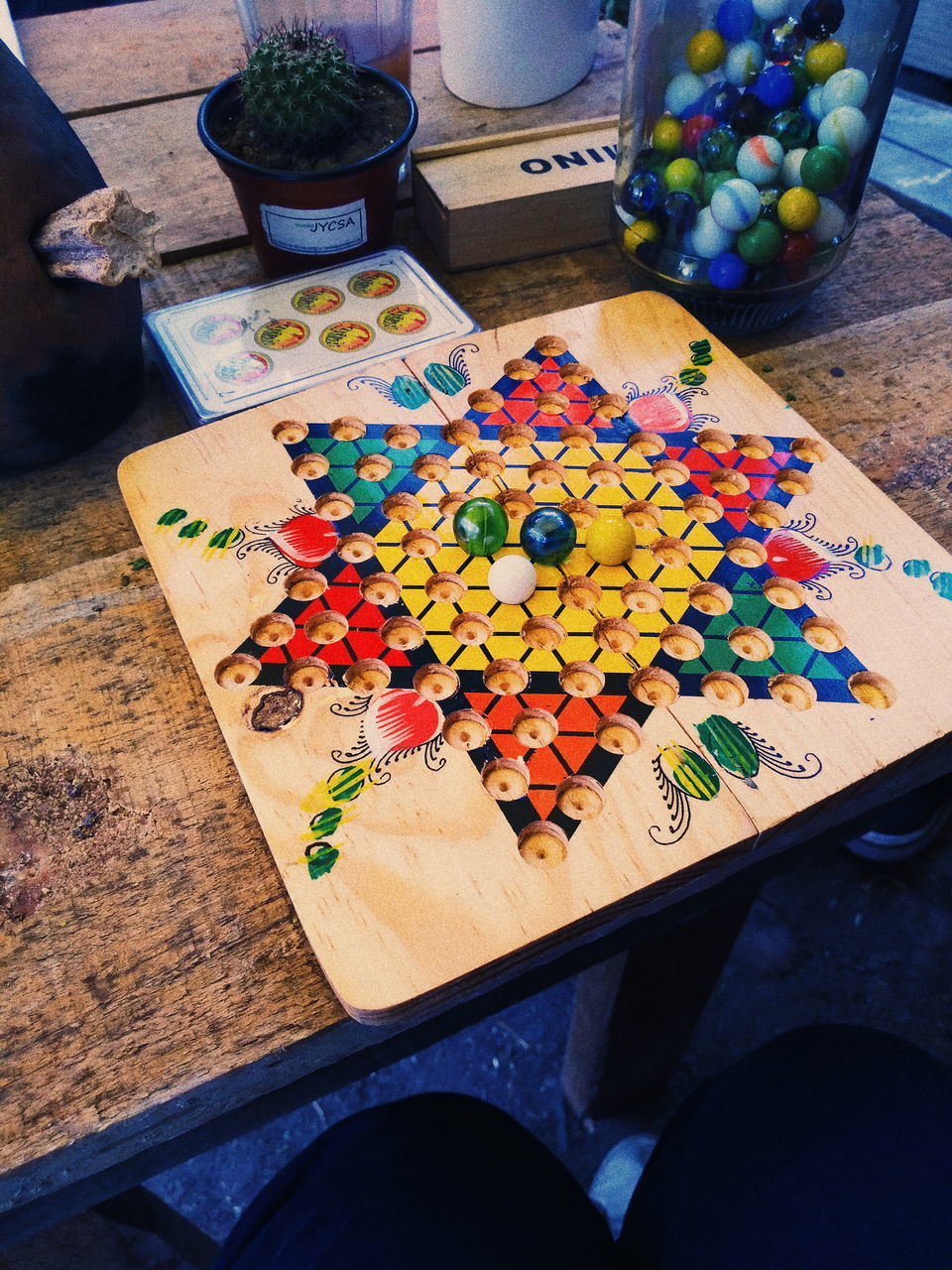 multi colored, high angle view, table, large group of objects, indoors, wood - material, choice, variation, still life, craft, art and craft, leisure activity, leisure games, no people, creativity, paper, abundance, close-up, arrangement, floral pattern