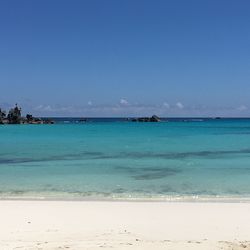 Scenic view of sea against blue sky