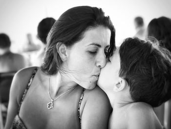 Close-up of mother and son kissing outdoors