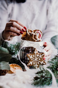 Midsection of woman holding dessert on table