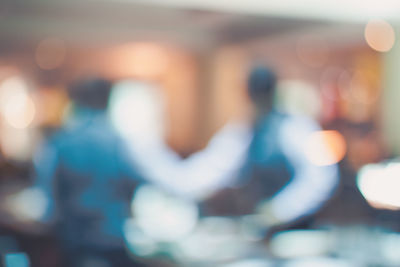 Defocused image of man standing in city