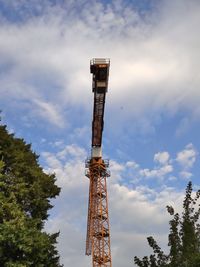 Low angle view of crane tower against sky