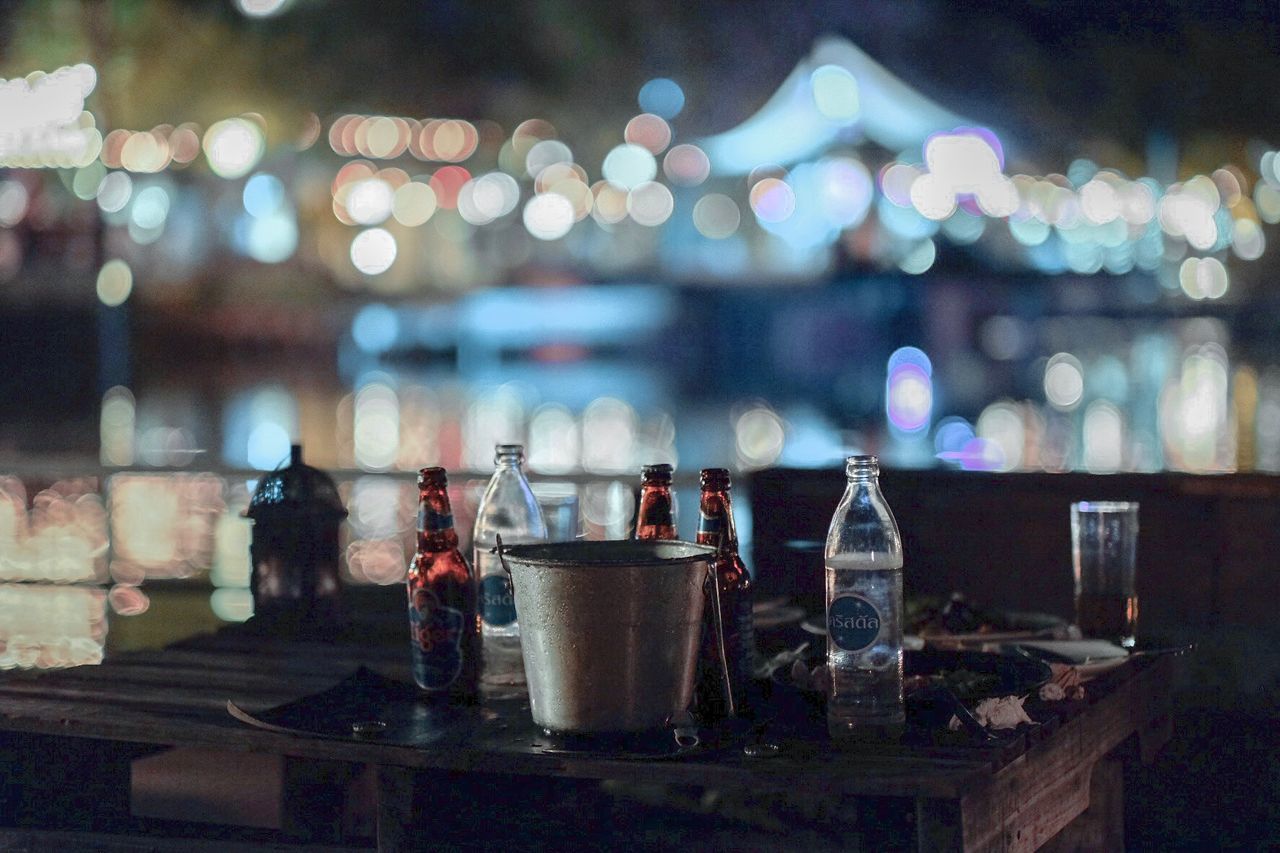 VIEW OF WINE GLASSES ON TABLE AT NIGHT