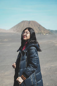 Young woman standing on a desert