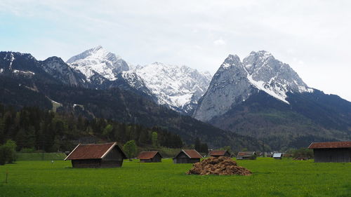 Scenic view of field and mountains against sky