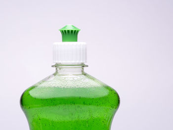 Close-up of glass bottle against white background